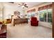 A cozy main bedroom boasts a wooden bed frame, a ceiling fan, and views through shuttered windows at 13434 W El Sueno Ct, Sun City West, AZ 85375
