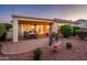 Inviting outdoor patio with brick pavers, dining set, and views of the lush desert landscape at 13434 W El Sueno Ct, Sun City West, AZ 85375