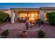 Relaxing covered patio featuring a dining set and comfortable seating area with desert landscape views at 13434 W El Sueno Ct, Sun City West, AZ 85375