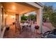 Comfortable covered patio with dining furniture and view of the desert landscape at 13434 W El Sueno Ct, Sun City West, AZ 85375