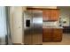 Kitchen featuring stainless steel refrigerator and wooden cabinets with laminate countertops at 1546 E Falcon Ct, Casa Grande, AZ 85122