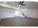 Spacious finished basement with gray-toned plank flooring, stairway, and recessed lighting at 1550 N Stapley Dr # 31, Mesa, AZ 85203