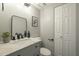 Elegant bathroom featuring a vanity with granite countertop, modern fixtures, and framed mirror at 15801 N 29Th St # 11, Phoenix, AZ 85032