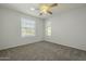 Bright bedroom with two windows, ceiling fan, and neutral carpet, creating a serene space at 15801 N 29Th St # 11, Phoenix, AZ 85032