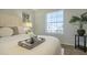 Cozy bedroom featuring a plush bed, modern decor, and ample natural light from the window at 15801 N 29Th St # 11, Phoenix, AZ 85032