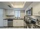 Kitchen with stainless steel appliances and white cabinets at 15801 N 29Th St # 11, Phoenix, AZ 85032