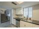 Kitchen with black countertop and view of stairway at 15801 N 29Th St # 11, Phoenix, AZ 85032