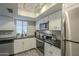 Well-lit kitchen featuring modern appliances and white cabinetry at 15801 N 29Th St # 11, Phoenix, AZ 85032