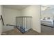 Staircase leading to a cozy bedroom with a white cushioned headboard and neutral colored walls at 15801 N 29Th St # 11, Phoenix, AZ 85032