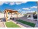 Gazebo featuring comfortable outdoor seating, set against artificial turf and gravel, perfect for relaxation and entertaining at 16918 W Statler St, Surprise, AZ 85388