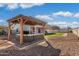 Backyard gazebo with outdoor seating on pavers and artificial turf, creating an inviting outdoor living space at 16918 W Statler St, Surprise, AZ 85388