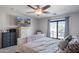 Bright bedroom with a ceiling fan and a sliding glass door to a private balcony at 16918 W Statler St, Surprise, AZ 85388