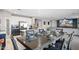 A dining room adjacent to an open kitchen and living area at 16918 W Statler St, Surprise, AZ 85388