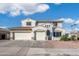 Charming stucco home with a three-car garage, complemented by stone accents and tile roofing at 16918 W Statler St, Surprise, AZ 85388