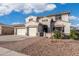 Inviting home featuring a three-car garage, beautiful landscaping, and a private gated entrance at 16918 W Statler St, Surprise, AZ 85388