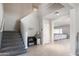 Inviting foyer features a staircase, tile flooring and seating area with decor at 16918 W Statler St, Surprise, AZ 85388