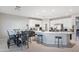 Modern kitchen with a center island, white cabinets, stainless steel appliances, and breakfast area at 16918 W Statler St, Surprise, AZ 85388