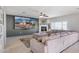 A living room with a stone fireplace, gray accent wall, and large sofa at 16918 W Statler St, Surprise, AZ 85388