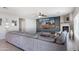 Spacious living room with fireplace and large gray sectional at 16918 W Statler St, Surprise, AZ 85388
