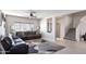 Open-concept living area featuring tile floors, a ceiling fan, and a spacious layout at 16918 W Statler St, Surprise, AZ 85388