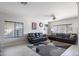 Comfortable living room with tile flooring, large windows and plush leather seating at 16918 W Statler St, Surprise, AZ 85388