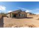 Exterior of home featuring covered patio and large backyard at 17462 W Straight Arrow Ln, Surprise, AZ 85387