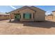 Home exterior featuring covered patio and large backyard at 17462 W Straight Arrow Ln, Surprise, AZ 85387