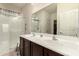 Bathroom featuring double sink vanity and glass-enclosed shower with chrome fixtures at 17462 W Straight Arrow Ln, Surprise, AZ 85387
