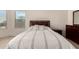Cozy bedroom with bright window, side table and dresser at 17462 W Straight Arrow Ln, Surprise, AZ 85387