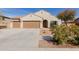 Charming single-story home featuring a three-car garage, desert landscaping, and a neutral color palette at 17462 W Straight Arrow Ln, Surprise, AZ 85387