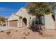 Beautiful single-story home with a well-manicured yard, three-car garage, and a cozy entryway at 17462 W Straight Arrow Ln, Surprise, AZ 85387