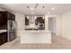 Bright and airy kitchen featuring a central island, stainless steel appliances, and sleek pendant lights at 17462 W Straight Arrow Ln, Surprise, AZ 85387