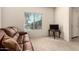 Cozy sitting area with a comfortable couch, TV, and natural light from a large window at 17462 W Straight Arrow Ln, Surprise, AZ 85387