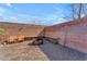 A cozy backyard area with a built-in seating, gravel, brick walls, and a fire pit at 17473 N 167Th Dr, Surprise, AZ 85374