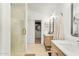 Modern bathroom features double sink vanity with stylish mirrors, walk-in closet, and a glass door shower at 17473 N 167Th Dr, Surprise, AZ 85374