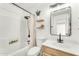 Bright bathroom with updated fixtures, decorative shelves, and a shower-tub combo at 17473 N 167Th Dr, Surprise, AZ 85374