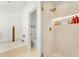 This bathroom has a soaking tub and a walk-in shower with built-in shelves and gold hardware at 17473 N 167Th Dr, Surprise, AZ 85374