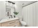 Bright bathroom featuring modern vanity with a designer mirror, and a shower-tub combination with stylish fixtures at 17473 N 167Th Dr, Surprise, AZ 85374