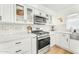 Stylish kitchen with white cabinets, stainless steel appliances, and subway tile backsplash at 17473 N 167Th Dr, Surprise, AZ 85374