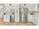 Contemporary kitchen features stainless steel appliances, wine storage, and custom cabinetry at 17473 N 167Th Dr, Surprise, AZ 85374