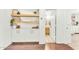 Stylish built-in cabinets with decorative shelving, with open doorway to a bathroom, enhancing the home's charm at 17473 N 167Th Dr, Surprise, AZ 85374