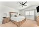 Bright main bedroom featuring a king-size bed, side tables, complemented by a ceiling fan and natural light at 17473 N 167Th Dr, Surprise, AZ 85374