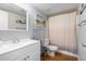 Well-lit bathroom featuring a vanity with mirror, a shower with curtain, and shelving at 18202 N Cave Creek Rd # 134, Phoenix, AZ 85032