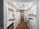 Well-lit kitchen with stainless steel sink, white cabinets, and updated appliances at 18202 N Cave Creek Rd # 134, Phoenix, AZ 85032
