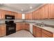 Well-lit kitchen showcasing oak cabinetry, neutral countertops, and tile flooring at 1933 W Ocotillo Rd, Phoenix, AZ 85015