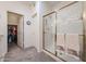 Bright bathroom featuring a glass-enclosed shower and a walk-in closet at 19427 N 84Th Ave, Peoria, AZ 85382