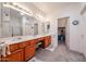 Bathroom featuring dual sinks, walk in closet access and lots of bright light at 19427 N 84Th Ave, Peoria, AZ 85382