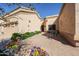 Private outdoor courtyard area with brick pavers, seating area, and lush landscaping at 19427 N 84Th Ave, Peoria, AZ 85382