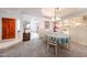 Bright dining area featuring carpet, chandelier, and view to the entry and kitchen at 19427 N 84Th Ave, Peoria, AZ 85382