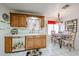 Well-lit kitchen with tile floors, wood cabinets, and a dining area; perfect for casual meals at 19427 N 84Th Ave, Peoria, AZ 85382